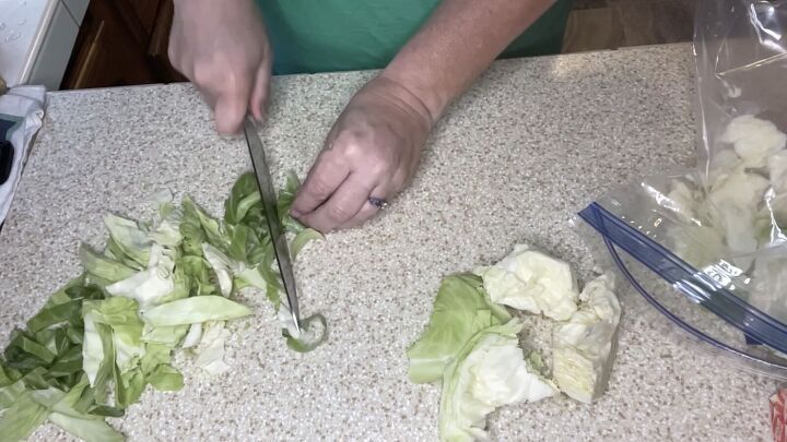 a cheap easy cabbage pasta recipe inspired by the great depression, Cutting up the cabbage