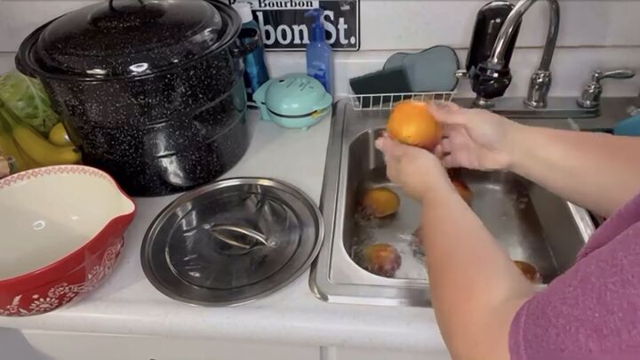 want to save the summer s peaches try this easy peach canning recipe, Placing the blanched peaches in ice water