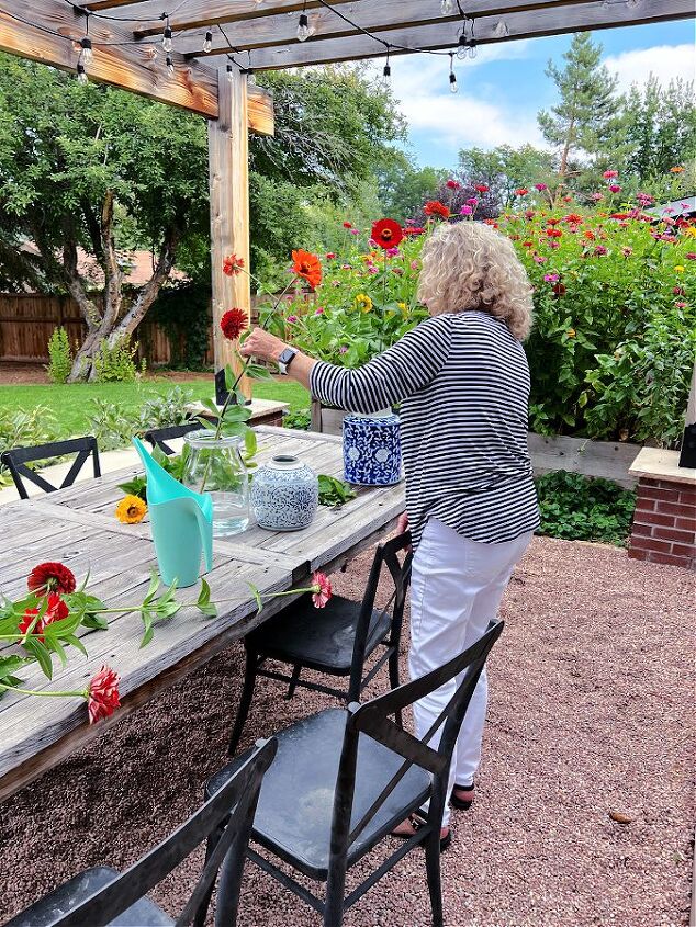 natural and simple decorating ideas for fall, My darling mom helping arrange zinnias for Fall decor