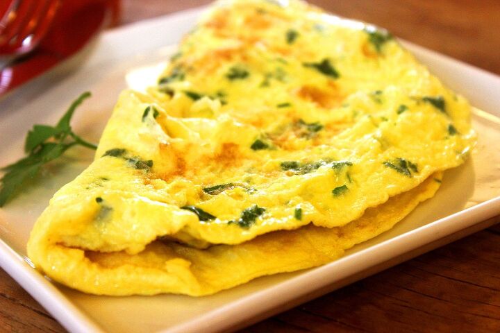 egg dinner recipes that save you money, egg and chive omelet on white square dish