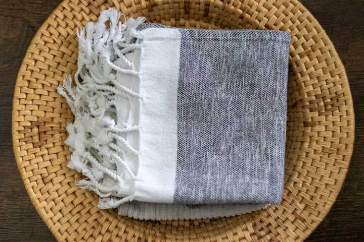 changes we ve made to live more sustainably, pile of turkish towels in basket ditch the paper towels and use washable towels