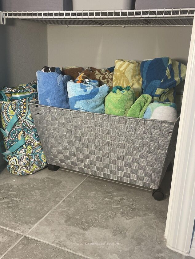 15 awesome storage solutions for your bathroom, Beach towels stored in a basket with wheels in the bathroom closet