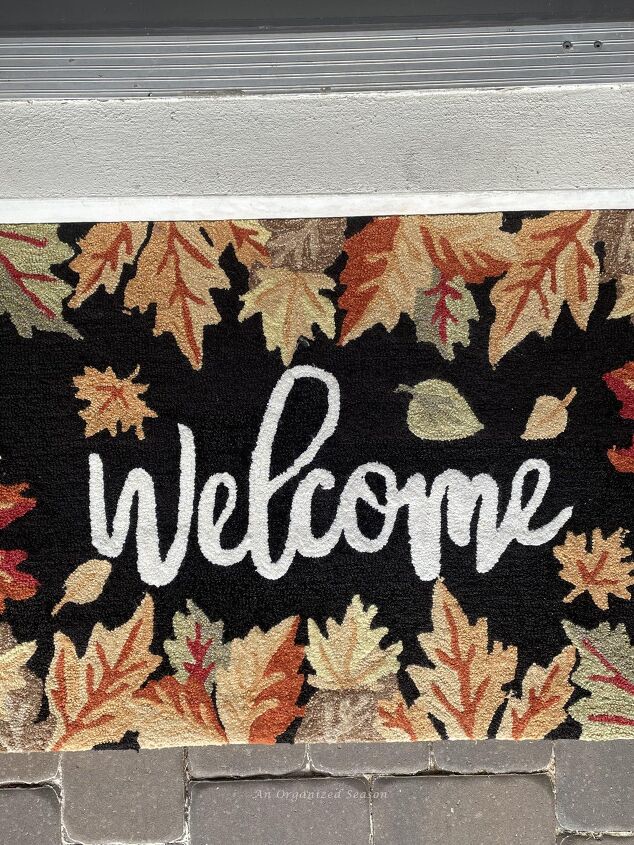 budget decorating ideas for an amazing fall porch, A fall rug that says welcome Reuse it each year for a budget decorating ideas for fall porch