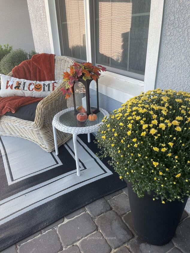 budget decorating ideas for an amazing fall porch, A large potted yellow mum sitting on a porch Buy it from Costco for a Budget decorating ideas for fall porch