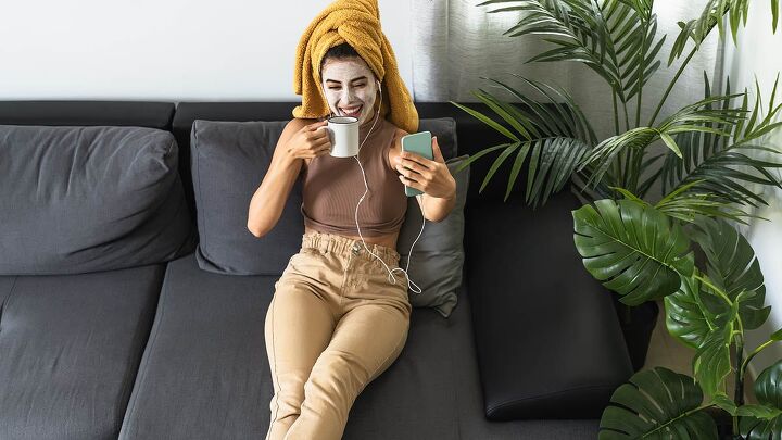 5 super easy diy beauty products that simply work, Woman wearing DIY beauty mask at home sips coffee and smiles at her smartphone