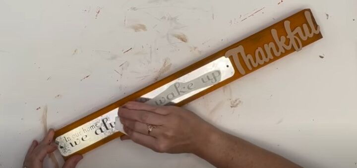 how to use dollar tree faux leather items in diy fall decor, Applying decal to the sign