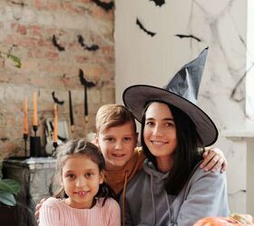 best ways to save money on halloween, a family with homemade Halloween costumes sitting at the table