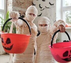 best ways to save money on halloween, two children dressed as mummies for Halloween