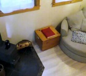 tiny house tour in nelson bc what it s like staying in a tiny home, Living room in a tiny house with a wood stove