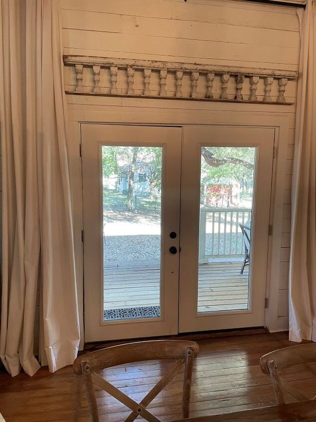architectural salvage decorating ideas, French doors with old porch railing displayed above them