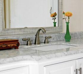 how to spring clean your bathroom, Close up of bathroom sink with marble counter and mirror behind it