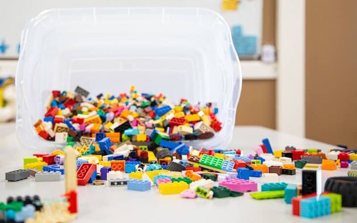 how to save money on toys, a bin of Legos tipped over