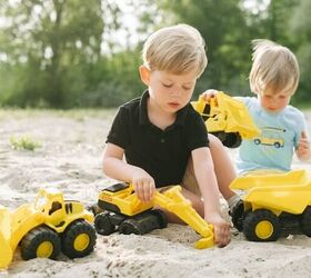 how to save money on toys, two boys playing in the sand with trucks