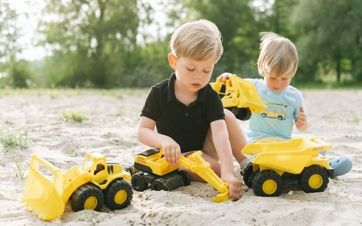 how to save money on toys, two boys playing in the sand with trucks