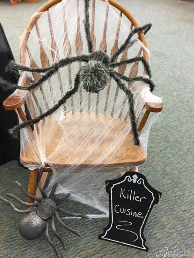 throw an easy halloween party on a scary small budget, Halloween spider webs stretched over chair with furry spider and chalkboard tombstone