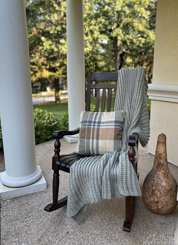 easy fall front porch ideas that won t break the bank, Throw blanket and fall plaid pillow on porch rocker
