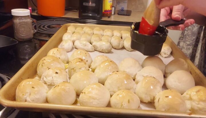 15 cheap party meal for 10 people stromboli garlic bites cookies, Brushing the garlic bites with butter