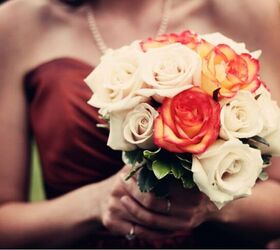 fall wedding ideas on a budget, a woman in a maroon dress holding cream and orange roses