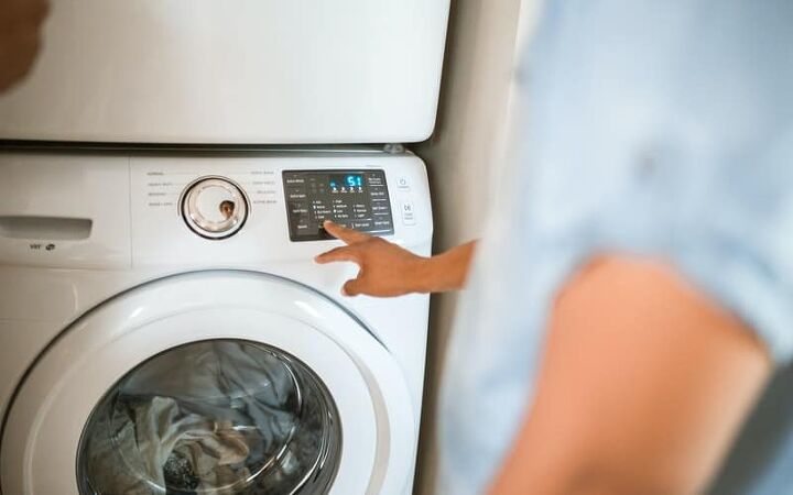 10 tips for being fashionable on a budget, person pressing a button on a washing machine