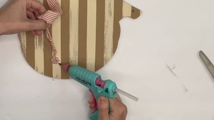 7 crafty ways to use dollar tree fabric this fall, Gluing a piece of fabric to the pumpkin
