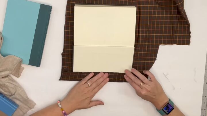 7 crafty ways to use dollar tree fabric this fall, Gluing fabric to a book