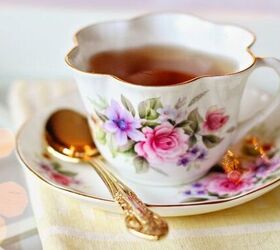18 frugal home must haves to save money, old fashioned flower patterned tea cup and saucer with a gold coloured spoon filled with black tea