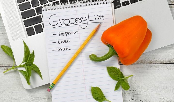 budget grocery list the best cheapest foods for tight budgets, Half written budget grocery list for the week of frugal recipeswith pencil and orange pepper next to it on a desktop
