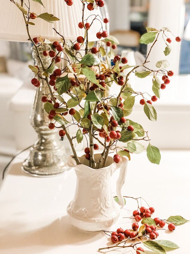 5 ways to celebrate christmas on a budget, pitcher with branches and berries that I found in my yard for a way to celebrate christmas on a budget
