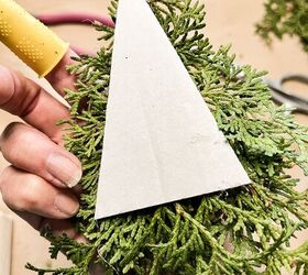 how to use greenery for christmas diy projects, Add cedar greenery for Christmas to tree shaped cardboard for DIY holiday decorations