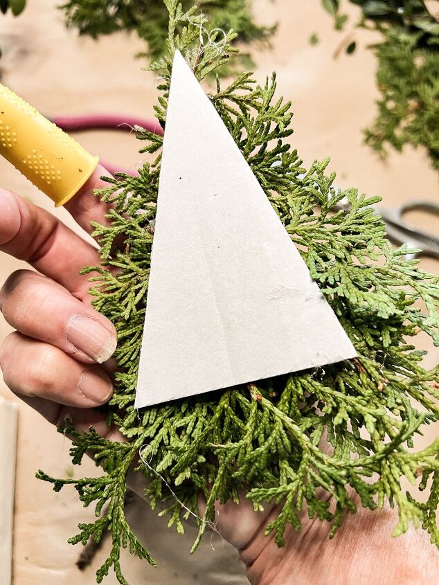 how to use greenery for christmas diy projects, Add cedar greenery for Christmas to tree shaped cardboard for DIY holiday decorations