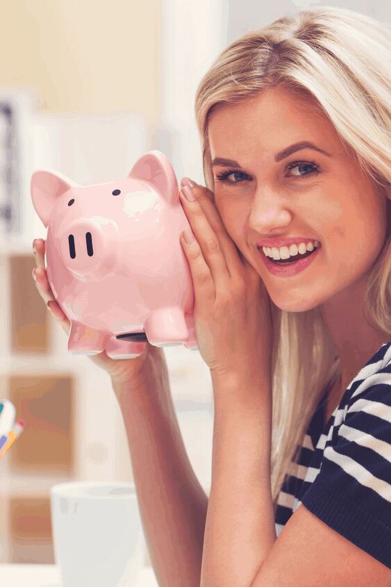 living on a tight budget 15 simple ways to save money in 2023, woman holding a piggy bank