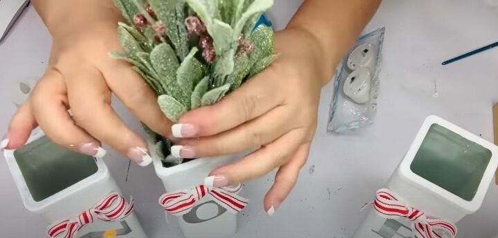 8 festive dollar tree christmas diys craft projects, Adding greenery to the vases