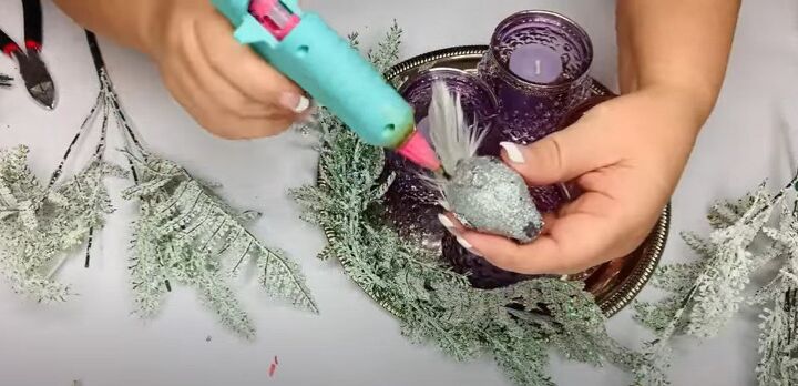 8 festive dollar tree christmas diys craft projects, Hot glueing the greenery to the tray