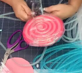 8 candy themed diy dollar tree christmas crafts, Wrapping the lollipop in a cello bag
