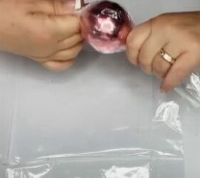 8 candy themed diy dollar tree christmas crafts, Rolling the cellophane around the ball