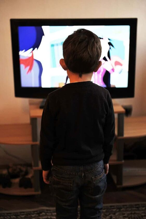 things to stop buying to save money, child sitting in front of cable tv