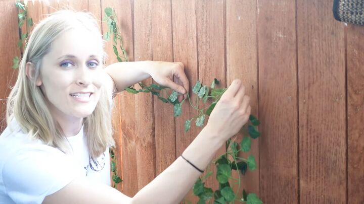 super cheap cute tiny balcony makeover ideas on a budget, Tacking the ivy to the fence