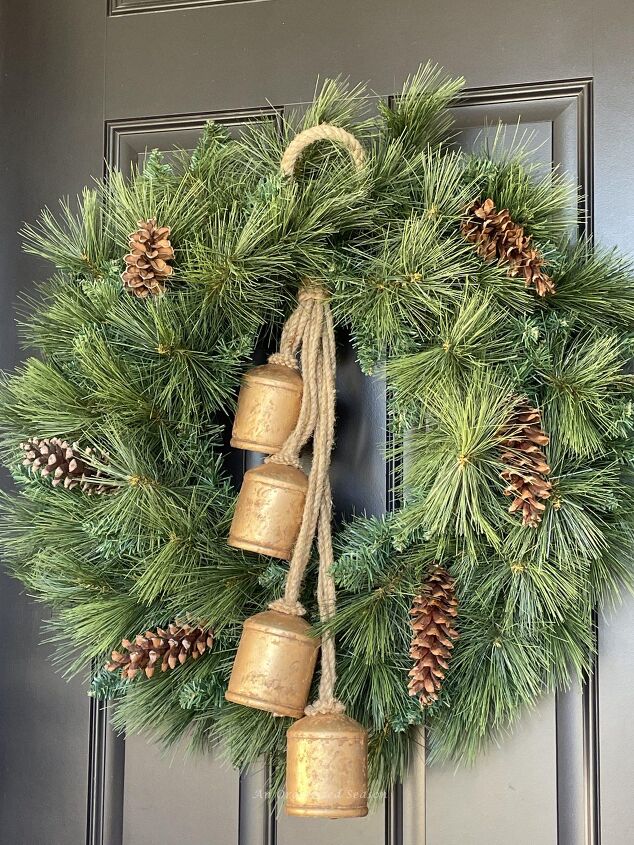 seven ways to decorate for christmas on a budget, An evergreen wreath decorated with pine cones and antique bells is a good way to decorate for Christmas on a budget