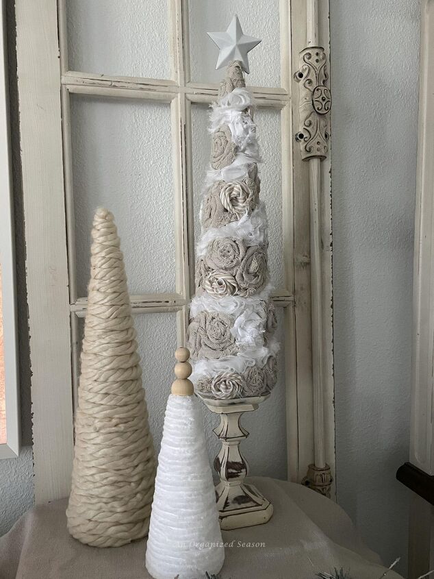 seven ways to decorate for christmas on a budget, Cone Christmas trees made with yarn drop cloth pieces and ribbon