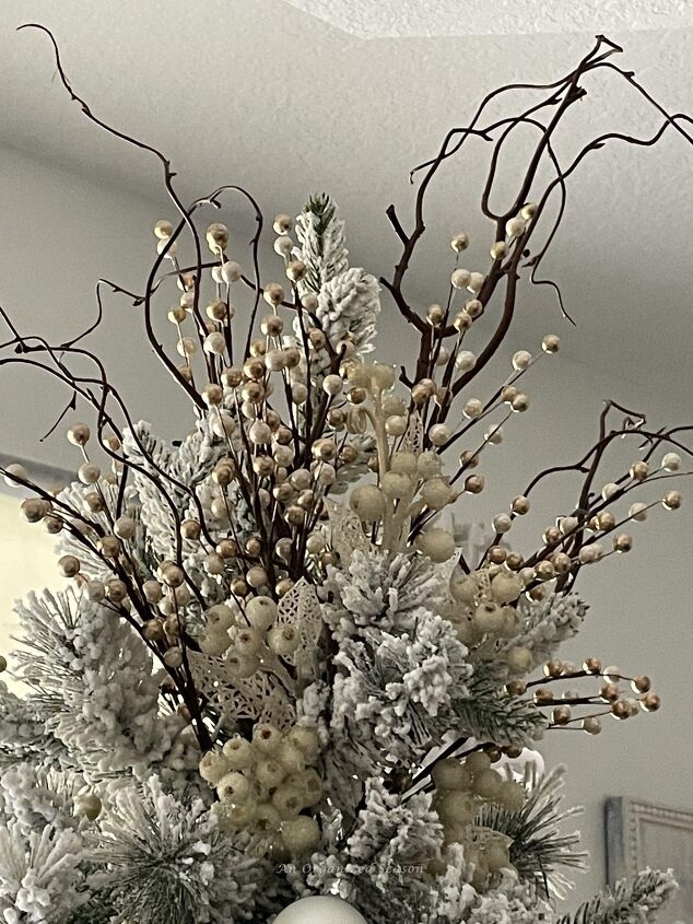 seven ways to decorate for christmas on a budget, A Christmas tree topper made from tree branches white berries and champagne and white floral picks