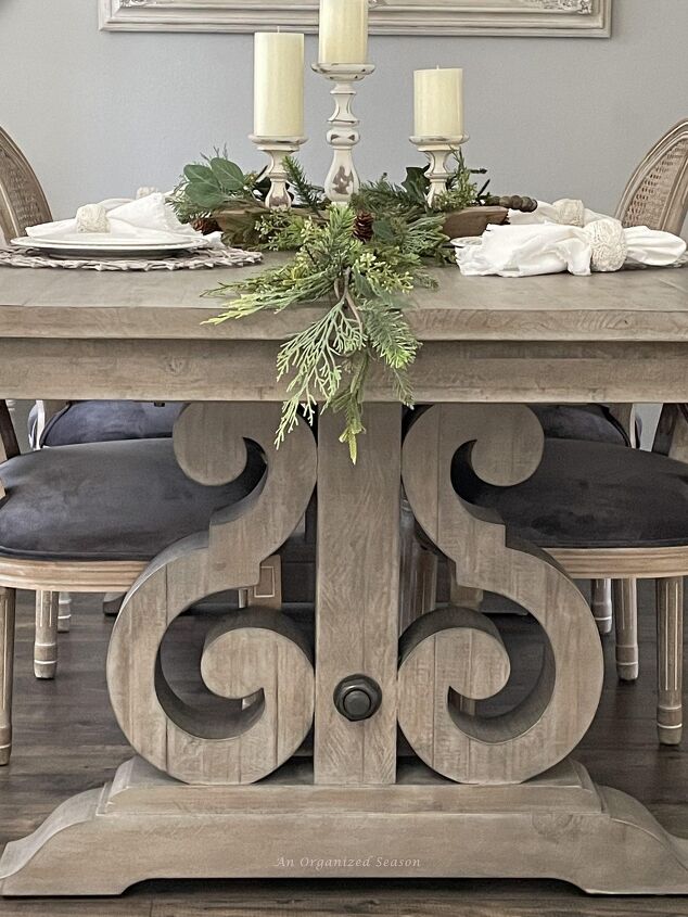 how to get organized for holiday entertaining, A dining room table decorated with greenery and ready for holiday entertaining