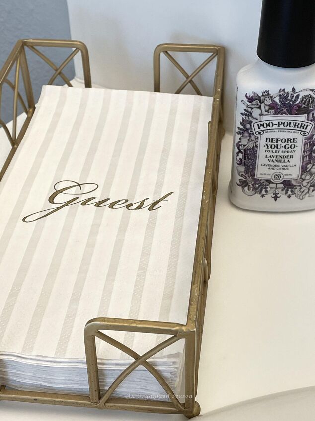 how to get organized for holiday entertaining, Guest hand towels and Poo pourri spray on a bathroom counter