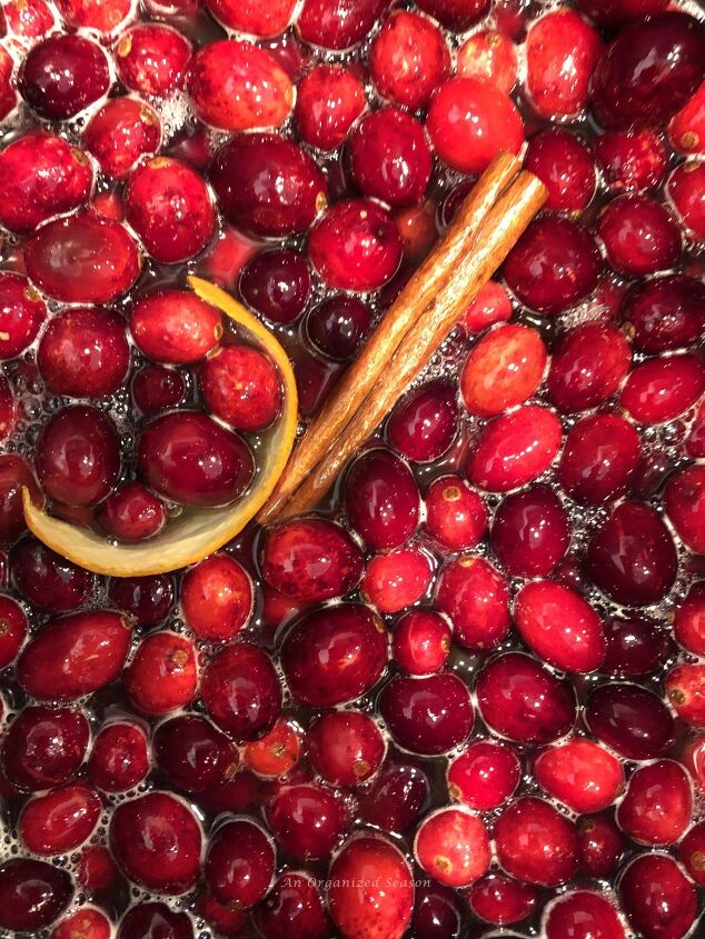 how to get organized for holiday entertaining, Cranberries cinnamon stick and orange peel simmering in a pot