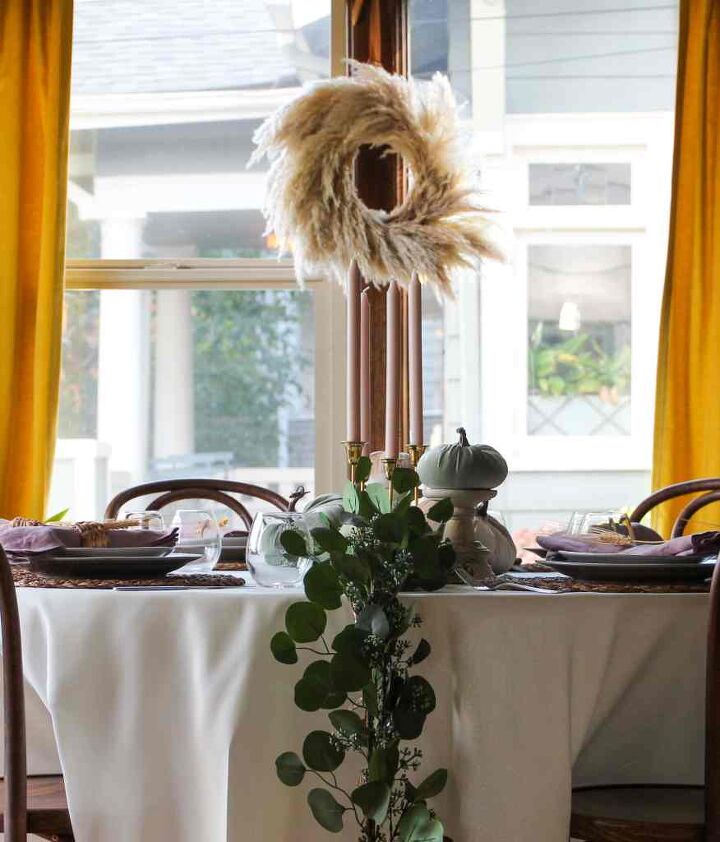 how to use a garland for everyday holidays, Dining room with wreath on window Candles on table with faux garland for everyday and holidays
