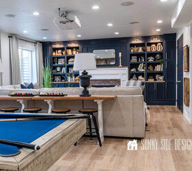 10 sensational home improvement ideas on a budget, Laminate floor installed over concrete in a basement family room with bold navy blue built ins