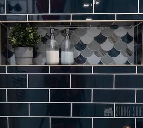 10 sensational home improvement ideas on a budget, Home improvement ideas install a tile shower surround navy blue subway tile with a shell mosaic shower niche