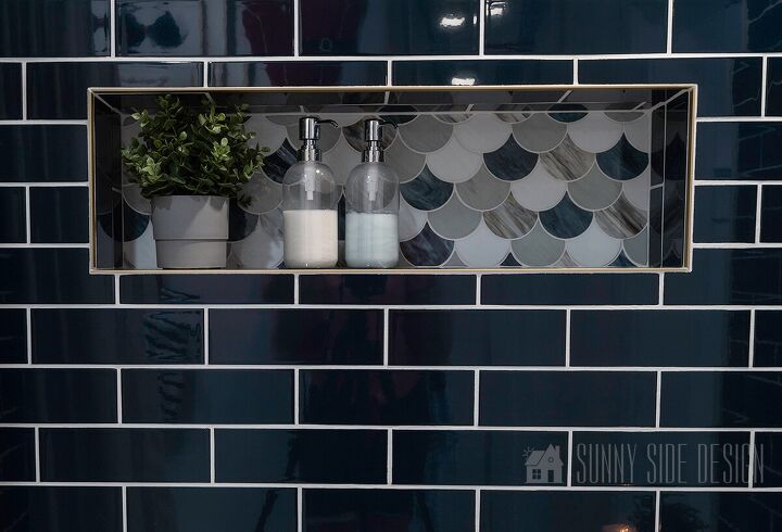 10 sensational home improvement ideas on a budget, Home improvement ideas install a tile shower surround navy blue subway tile with a shell mosaic shower niche