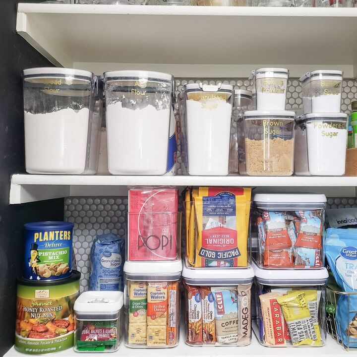 30 affordable pantry organization storage ideas you need to see, Pantry organization ideas white pantry shelves with a white penny tile backing Clear container store dry goods like flour sugars baking powder neatly labeled Clear storage boxes store small packaged food
