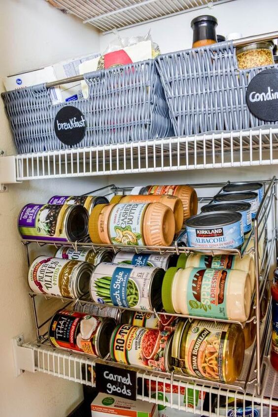 30 affordable pantry organization storage ideas you need to see, Pantry Organization Ideas White wire pantry shelves are organized with basket for breakfast foods condiments and rolling storage for canned goods