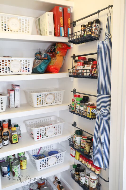 30 affordable pantry organization storage ideas you need to see, Pantry Organization Ideas White plastic bins are used to organize packaged foods hanging baskets along wall create additional storage for small items and spices